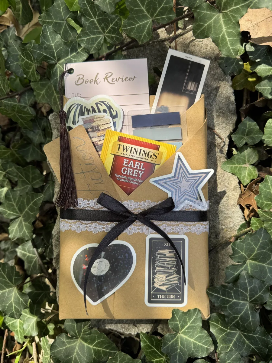 Wrapped book package with tea, stickers, and reading extras